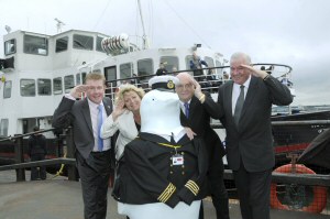 Cllr Mark Dowd and Cllr Chris Blakeley are joined by Cllr Warren Bradley, Sally-Ann Wilkinson and Perry the Penguin on board the Royal Iris to launch Merseytravels partnership in Go Penguins.