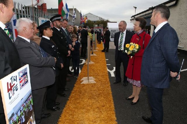 Kim Antoine (third from left) and PC Dan Holdsworth (fourth from left) are visited by HRH Princess Anne in honour of their foreign aid work.