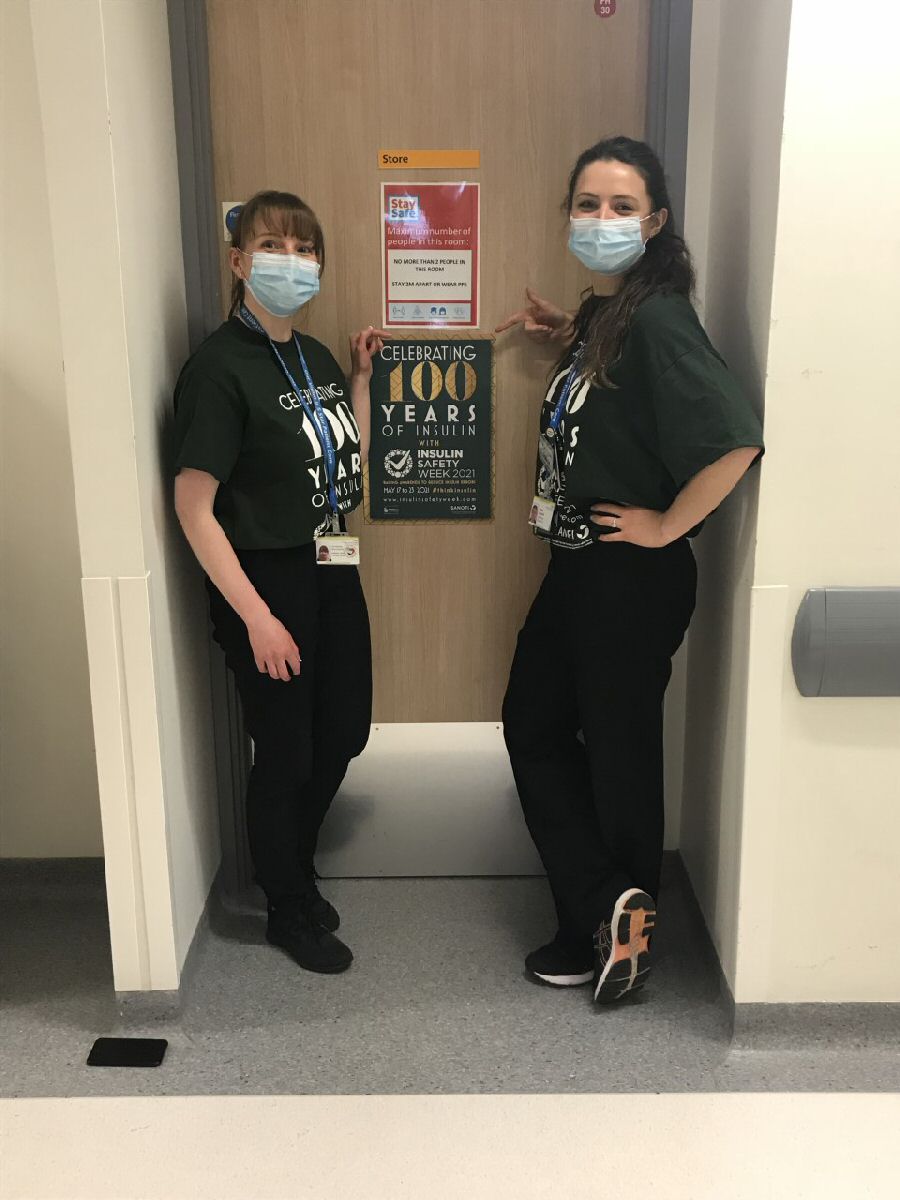 2 members of the St Helens and Knowsley Diabetes Team who have won the prominent award for raising awareness of insulin safety next to a  poster.