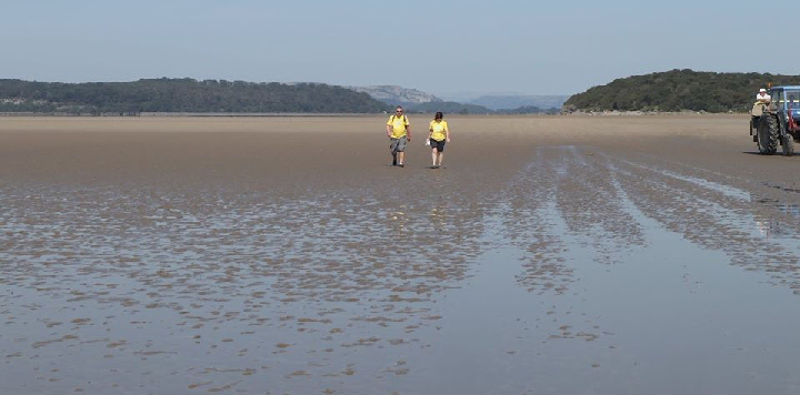 2 people taking part in a walk observing social distant rules... Terry Hazell, who took part in 2019 Morecambe Bay Walk, encourages people to get creative and walk 8 miles